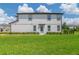 Charming two-story townhouse featuring a well-kept lawn and inviting light-blue front door at 1754 Sanibel Dr, Davenport, FL 33896