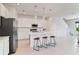 Bright, white kitchen featuring an island with bar stool seating and stainless steel appliances at 1754 Sanibel Dr, Davenport, FL 33896