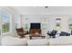 Bright living room with large windows, comfortable seating, and a wooden entertainment center at 1754 Sanibel Dr, Davenport, FL 33896