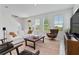 Open living area with sofa, leather chairs, area rug, and large windows with outdoor views at 1754 Sanibel Dr, Davenport, FL 33896