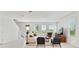 An open concept living area with tile floors, light colored sofa and chairs, and natural light from large windows at 1754 Sanibel Dr, Davenport, FL 33896