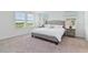 Well-lit main bedroom features carpeted floors, a gray bed frame, and lovely large windows at 1754 Sanibel Dr, Davenport, FL 33896