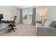 Comfortable home office with natural light, features desk, chair, and sofa for productivity at 1754 Sanibel Dr, Davenport, FL 33896