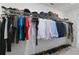 Well-organized walk-in closet with hanging clothes and shoe storage at 1754 Sanibel Dr, Davenport, FL 33896