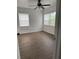 Comfortable bedroom with laminate flooring, ceiling fan, and natural light at 1820 Salem Rd, Lakeland, FL 33803