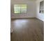 Bright bedroom featuring laminate flooring and natural light from large windows at 1820 Salem Rd, Lakeland, FL 33803