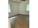 Clean bedroom featuring laminate flooring, ceiling fan, and natural light at 1820 Salem Rd, Lakeland, FL 33803