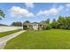 Charming single-story home with a well-manicured lawn under a bright, blue sky at 1820 Salem Rd, Lakeland, FL 33803