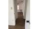 Hallway with laminate flooring leading to other rooms, showcasing the home's layout at 1820 Salem Rd, Lakeland, FL 33803