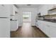 The bright kitchen features white cabinets and stainless steel appliances with plenty of natural light at 1820 Salem Rd, Lakeland, FL 33803