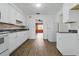 Clean kitchen featuring white cabinets, stainless steel appliances, and vinyl flooring at 1820 Salem Rd, Lakeland, FL 33803