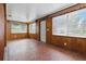 Sunroom featuring wood paneling, multiple windows, and neutral flooring at 1820 Salem Rd, Lakeland, FL 33803