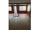 Bright living room with laminate flooring, wood paneled walls, and natural light at 1820 Salem Rd, Lakeland, FL 33803