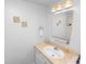 Clean bathroom with a single sink vanity, a large mirror, and neutral decor at 1823 Blue Lake Dr, Lakeland, FL 33801