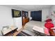 Cozy bedroom featuring a comfortable bed, dresser, TV, and dark curtains for added privacy at 1823 Blue Lake Dr, Lakeland, FL 33801