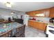 Kitchen with wood cabinets that offers a functional cooking space, complemented by a dining area and bright living space at 1823 Blue Lake Dr, Lakeland, FL 33801