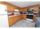 Well-lit kitchen with wood cabinets and a full set of appliances for a functional cooking space at 1823 Blue Lake Dr, Lakeland, FL 33801