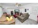 Cozy living room with comfortable couches, a ceiling fan, and a TV for relaxed indoor living at 1823 Blue Lake Dr, Lakeland, FL 33801