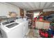 Practical utility room equipped with a washer, dryer, shelving, and storage solutions at 1823 Blue Lake Dr, Lakeland, FL 33801