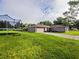 View of a single-story home with a trampoline in the well-maintained, grassy backyard at 1824 Baltic Pl, Lakeland, FL 33809