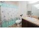 Bathroom featuring a shower with curtain, vanity with sink, and toilet at 1824 Baltic Pl, Lakeland, FL 33809