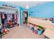 Blue bedroom with a loft bed, built-in shelving, and closet space for storage at 1824 Baltic Pl, Lakeland, FL 33809