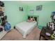 Cozy green bedroom with carpeted floors, a single bed, and desk at 1824 Baltic Pl, Lakeland, FL 33809