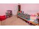 Cozy pink bedroom with carpet and furniture, perfect for a space at 1824 Baltic Pl, Lakeland, FL 33809