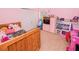 A bedroom with pink walls, closet space, and furniture creates a bright, inviting atmosphere at 1824 Baltic Pl, Lakeland, FL 33809