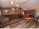 Spacious living room with wood-look floors flowing into the kitchen and dining area at 1824 Baltic Pl, Lakeland, FL 33809