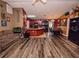 Living area with wood-look floors, opening to the kitchen and dining space at 1824 Baltic Pl, Lakeland, FL 33809