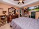 Spacious bedroom with a large dresser, tv, ceiling fan, and decorative touches at 1824 Baltic Pl, Lakeland, FL 33809