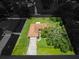 Aerial view of a single-story home with a large, tree-shaded yard and a two car garage at 1917 Lori W Ln, Lakeland, FL 33801
