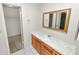 Bathroom with wood vanity and white countertop, and a large mirror at 1917 Lori W Ln, Lakeland, FL 33801