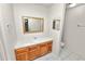 Bathroom with wood vanity and white countertop, plus a decorative mirror at 1917 Lori W Ln, Lakeland, FL 33801
