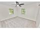 Bright bedroom with two windows providing ample natural light and neutral carpet at 1917 Lori W Ln, Lakeland, FL 33801