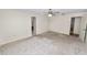Spacious bedroom featuring neutral carpet, ceiling fan, and two entry doors at 1917 Lori W Ln, Lakeland, FL 33801