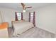 Bedroom featuring a large bed, two windows and neutral carpeting at 1917 Lori W Ln, Lakeland, FL 33801