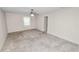 Spacious bedroom with neutral carpet, ceiling fan and a sunlit window at 1917 Lori W Ln, Lakeland, FL 33801