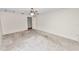 Generously sized bedroom features neutral carpet, ceiling fan, and two entry doors at 1917 Lori W Ln, Lakeland, FL 33801