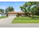 Charming single-story home with a well-manicured lawn and mature landscaping at 1917 Lori W Ln, Lakeland, FL 33801