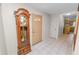 Foyer featuring tile flooring, a grandfather clock, and entry to the kitchen at 1917 Lori W Ln, Lakeland, FL 33801