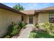 Inviting walkway leading to the front door, surrounded by well-maintained landscaping and flowering plants at 1917 Lori W Ln, Lakeland, FL 33801