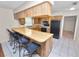 Traditional kitchen features a breakfast bar, tile floors, and ample cabinetry at 1917 Lori W Ln, Lakeland, FL 33801