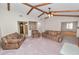 Large living room featuring an exposed beam ceiling, fireplace, and neutral carpeting at 1917 Lori W Ln, Lakeland, FL 33801