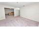 Open living room features mauve carpet and a view into the adjacent room at 1917 Lori W Ln, Lakeland, FL 33801