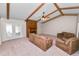 Bright living room featuring exposed beams, a fireplace, and double doors to the outside at 1917 Lori W Ln, Lakeland, FL 33801