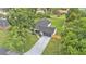 Aerial view of a home with a long driveway, a fenced backyard, and mature trees at 1920 Kimball S Ct, Lakeland, FL 33813