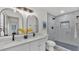Modern bathroom with double sinks, large mirrors, and a walk-in shower at 1920 Kimball S Ct, Lakeland, FL 33813