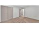 Empty bedroom features neutral carpet and sliding closet doors at 1920 Kimball S Ct, Lakeland, FL 33813